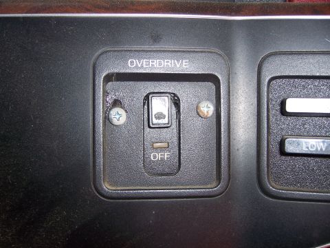 1991 Ford Bronco - Dashboard interior detail with an overdrive off switch and climate control buttons.