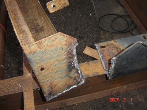 1993 Ford Bronco - Rusted metal parts, likely from a vehicle bumper or frame, are shown after being cut and welded.