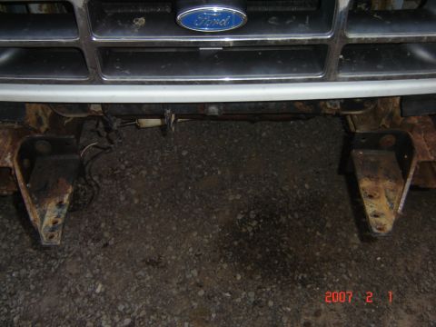 1993 Ford Bronco - Close-up of a Ford grille and rusted bumper mounts, indicating a 1992 model year.