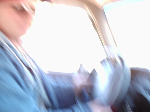 1996 Ford Bronco - Interior view of a vehicle with a driver, taken from a blurry perspective.