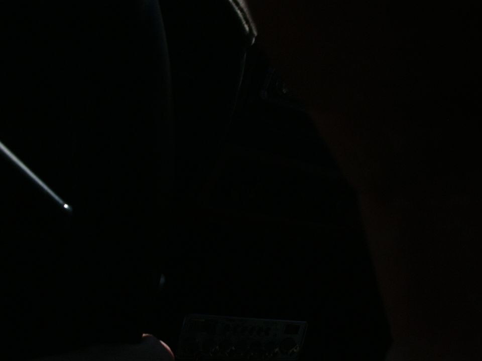 Dark vehicle interior with a beam of light hitting the dashboard