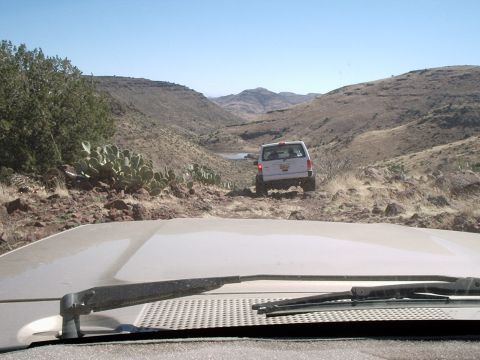 1996 Ford Bronco - Following a 1996 Ford Bronco on a dusty, rocky trail through a desert landscape.