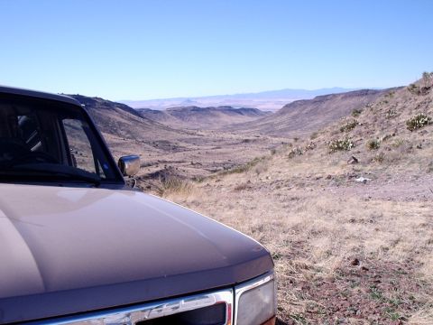 1996 Ford Bronco - Parked on a hillside, this 1996 Ford Bronco overlooks a vast desert landscape under a clear blue sky.