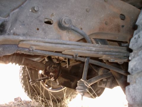 1996 Ford Bronco - Close-up of the rear axle and suspension system, showing leaf springs and other mechanical parts.