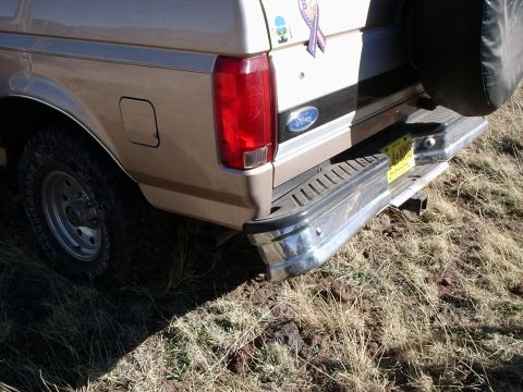 1996 Ford Bronco - Rear view of a tan Ford Bronco with a chrome bumper and a spare tire cover.