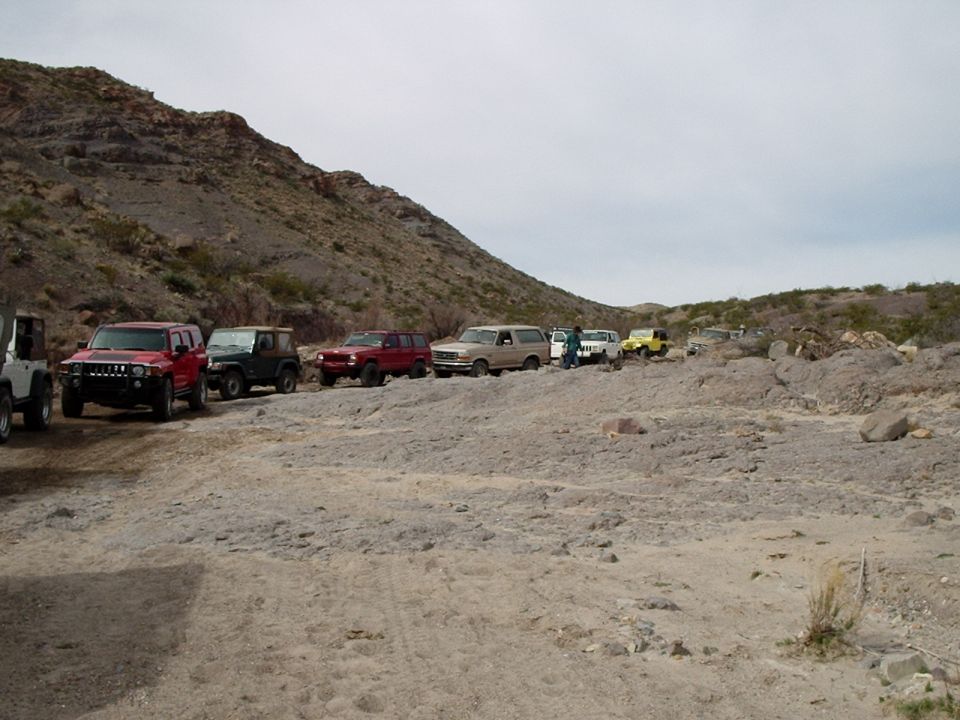 Tan SUV on rocky trail, 1990s body style