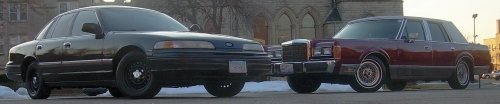 Maroon 1989 Lincoln Town Car parked next to a dark sedan