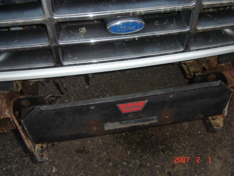 1993 Ford Bronco - Front view of a 1993 Ford Bronco grille and an aftermarket winch bumper with a WARN logo.