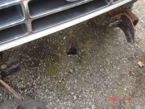 1993 Ford Bronco - Front view of a 1993 Ford Bronco's bumper, showing a tow hitch and part of the grille.