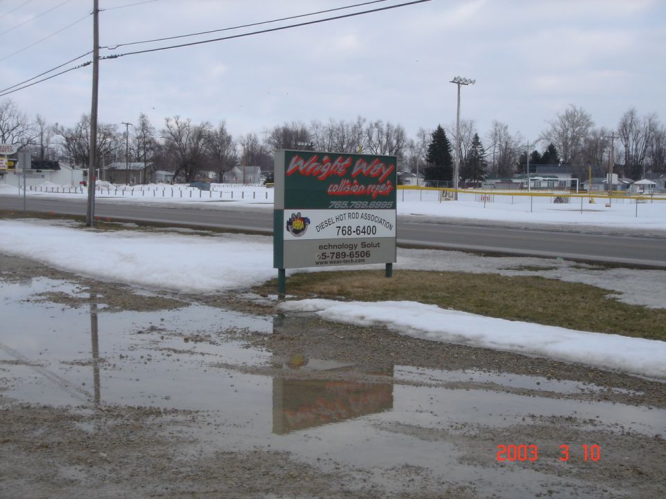 Business sign for Wright Way and Diesel Hot Rod Association in snow