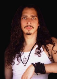 1990 Ford Bronco - Portrait of musician Chris Cornell against a dark background.