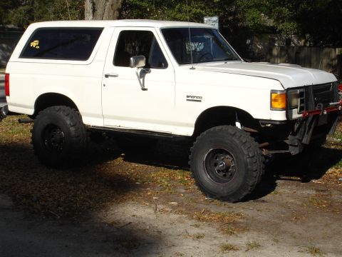 1989 Ford Bronco - This lifted 1989 Ford Bronco features prominent off-road tires and a stance.
