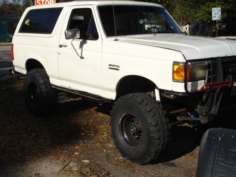 1989 Ford Bronco - White 1989 Ford Bronco modified with a lift kit and oversized tires.