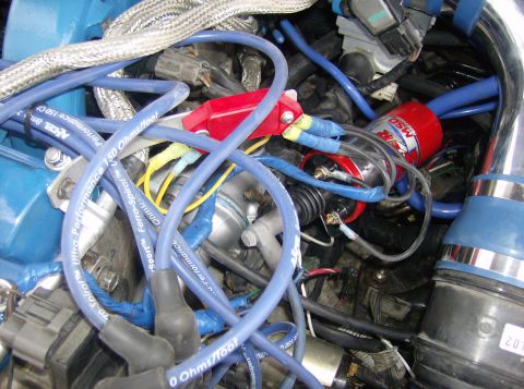 1996 Ford Probe - Close-up of an engine bay with various parts including spark plug wires and an ignition coil.