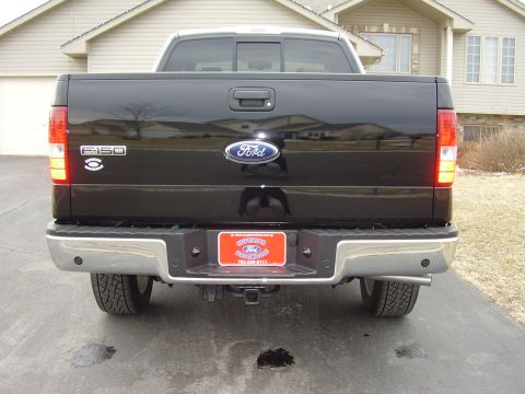 2007 Ford F-150 - Rear view of a black 2007 Ford F-150 pickup truck, the tailgate and chrome bumper.