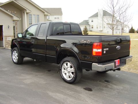2007 Ford F-150 - This black 2007 Ford F-150 pickup truck is shown from a three-quarter rear view.