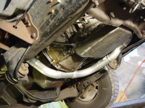 1991 Ford Bronco - Underside view of a truck's drivetrain and custom exhaust pipe installation.