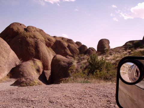 1996 Ford Bronco - A view from inside a vehicle shows a desert landscape with large rock formations and sparse vegetation.
