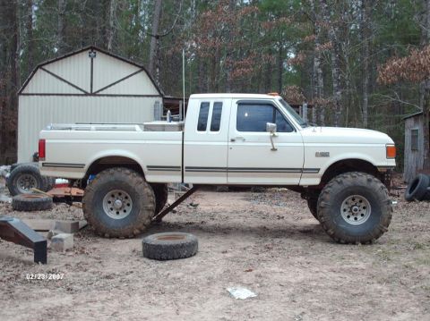 1990 Ford F-150 - This lifted 1990 Ford F-150 extended cab pickup features massive off-road tires and a custom suspension setup.