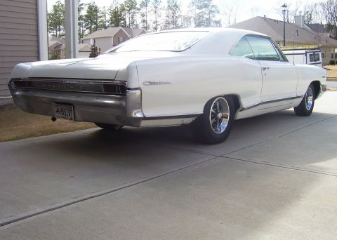1965 Pontiac Catalina - Rear three-quarter view of a white 1965 Pontiac Catalina coupe with custom wheels.