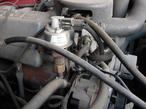 1990 Ford Bronco - A view of various engine components, including hoses and a labeled part, within a vehicle.