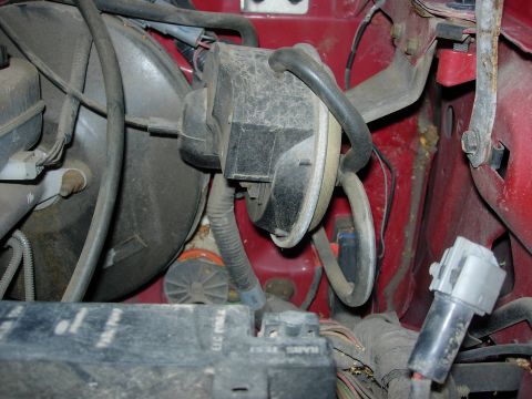 1990 Ford Bronco - Close-up view of engine bay components, including a brake booster and wiring harness.