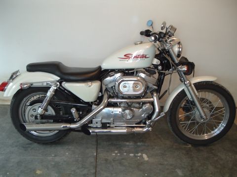 2000 Harley-Davidson Sportster - A white Harley-Davidson Sportster motorcycle is shown from the side against a plain wall.