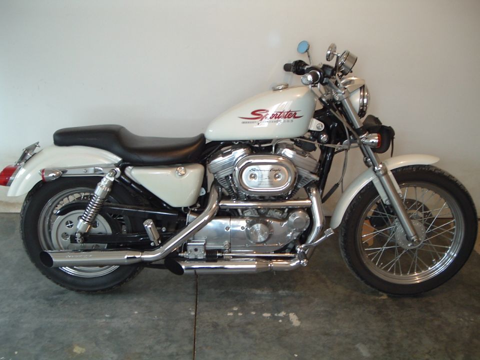 White Harley-Davidson Sportster motorcycle, right-side view, indoors on concrete