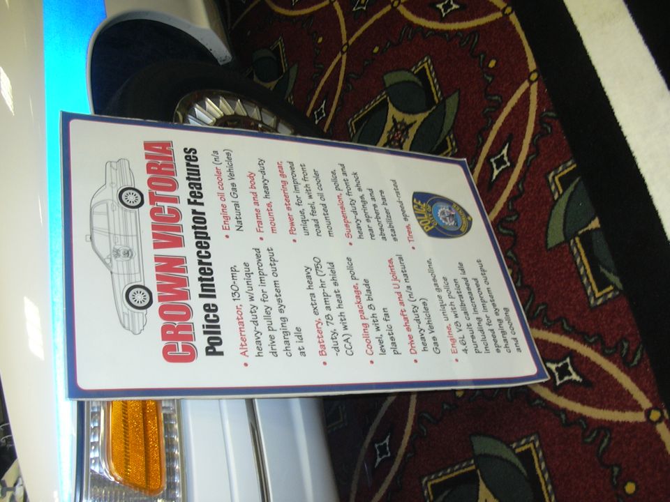 Crown Victoria Police Interceptor features display card beside the car