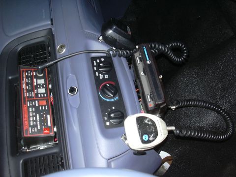 1996 Ford Crown Victoria - Center console of a 1996 Ford Crown Victoria equipped with radio and communication devices.
