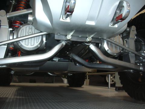 1996 Ford Crown Victoria - Close-up of the undercarriage reveals custom suspension components and dual exhaust systems on a unique vehicle.