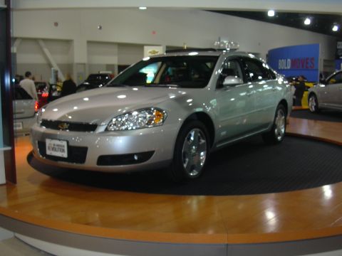 1996 Ford Crown Victoria - Silver Chevrolet Impala on display at an auto show, likely from the mid-2000s.
