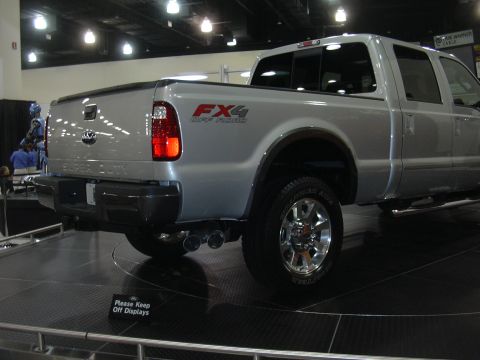 1996 Ford Crown Victoria - Silver Ford Super Duty pickup truck displayed at an auto show.