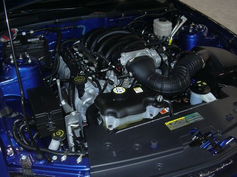 1996 Ford Crown Victoria - Close-up view of a clean engine bay, a prominent black intake system and blue painted components.