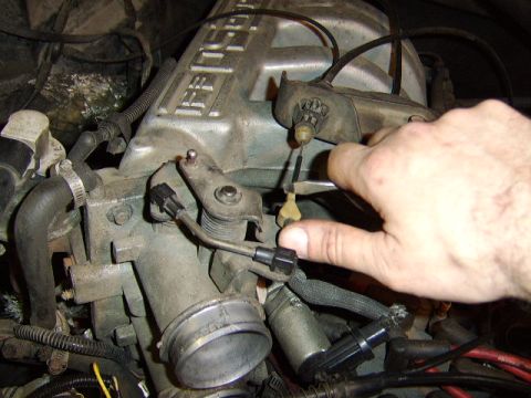 1989 Ford Bronco - the tranny cable is removed by pulling towards yourself and lifting up. At the bracket towards the rear, use a pair of pliers to squeese th…