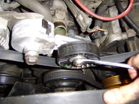 1989 Ford Bronco - I will now remove the belt by turning counterclockwise on the belt tensioner giving enough slack to allow me to slide the belt off the alt…