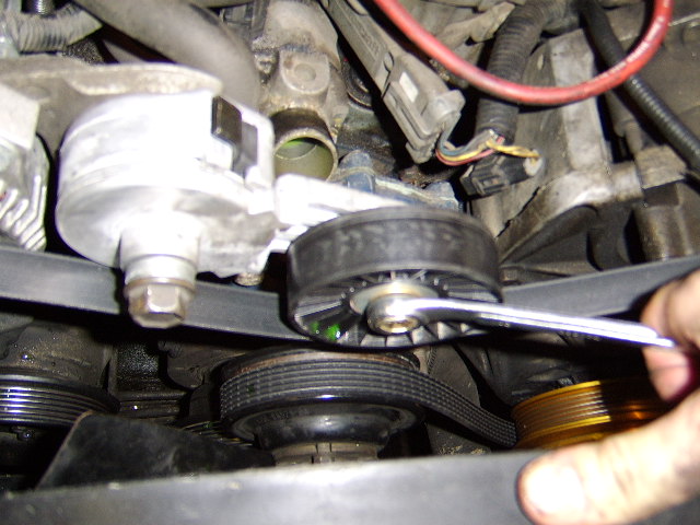 I will now remove the belt by turning counterclockwise on the belt tensioner giving enough slack to allow me to slide the belt off the alt pulley while applying counterclockwise pressure on the belt tensioner.