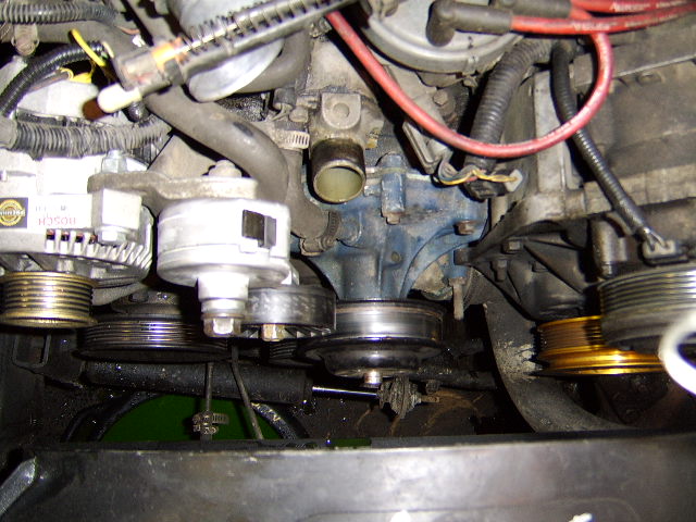 Front of an engine showing water pump, alternator and serpentine belt