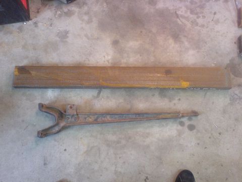 1967 Ford Bronco - Rusted metal parts, possibly from a vehicle restoration project, are laid out on a concrete surface.