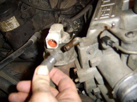 1989 Ford Bronco - next I removedthe plug from the egr valve and then the coolant hose at the top of the throttle body