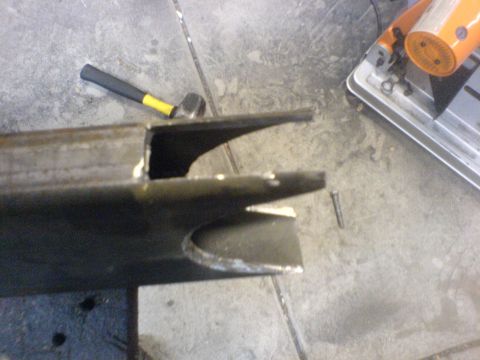 1967 Ford Bronco - Metal bracket and tools on a workshop floor.
