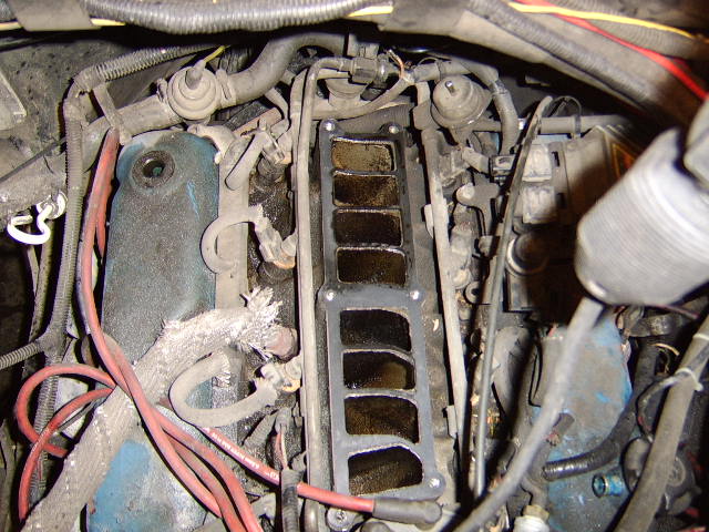In this pic, you can see the other end of the egr pipe going into the center of the intake. Soak it in penetrating fluid before removal