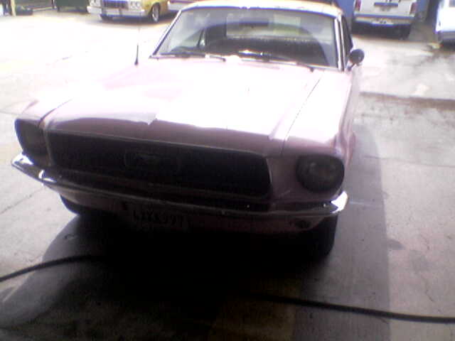 1967 Ford Mustang front view, pink color. License plate reads LMX 971