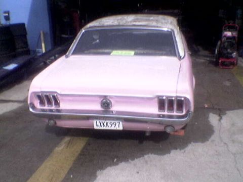 1988 Ford Bronco - This pink 1967 Ford Mustang features a classic rear end design with distinctive quad taillights and a prominent chrome bumper.