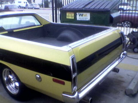 1988 Ford Bronco - This yellow pickup truck features a prominent black stripe along its side.