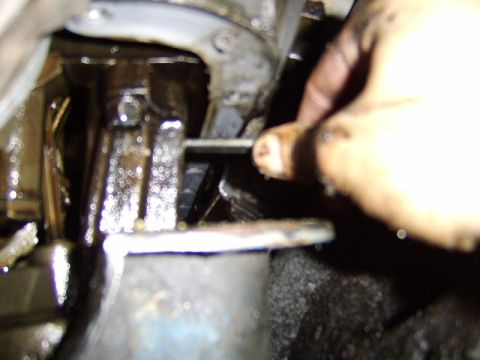 1989 Ford Bronco - here I am unbolting the oil pump itself, starting with the rear bolt. I should also add that there is a bolt securing the oil pick up tube…