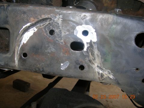 1991 Ford F-150 - This image shows significant damage and repair work on a vehicle's frame, with evidence of grinding and filler.