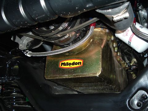 1966 Ford F-100 - Close-up of a Milodon oil pan, likely an aftermarket part for a vehicle.