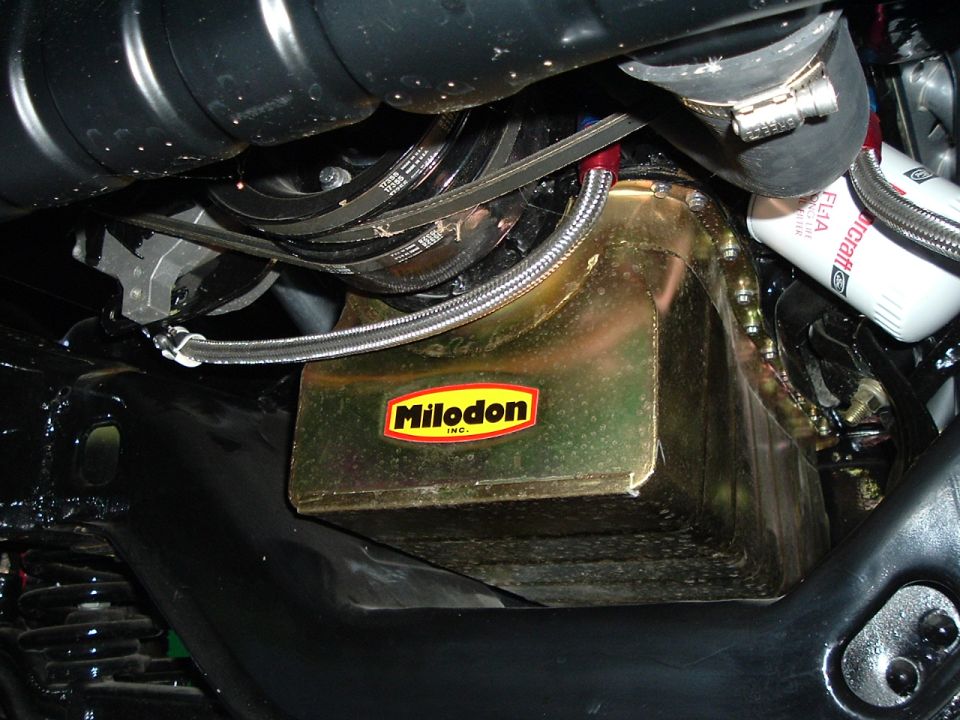 Engine oil pan with Milodon logo and braided oil line