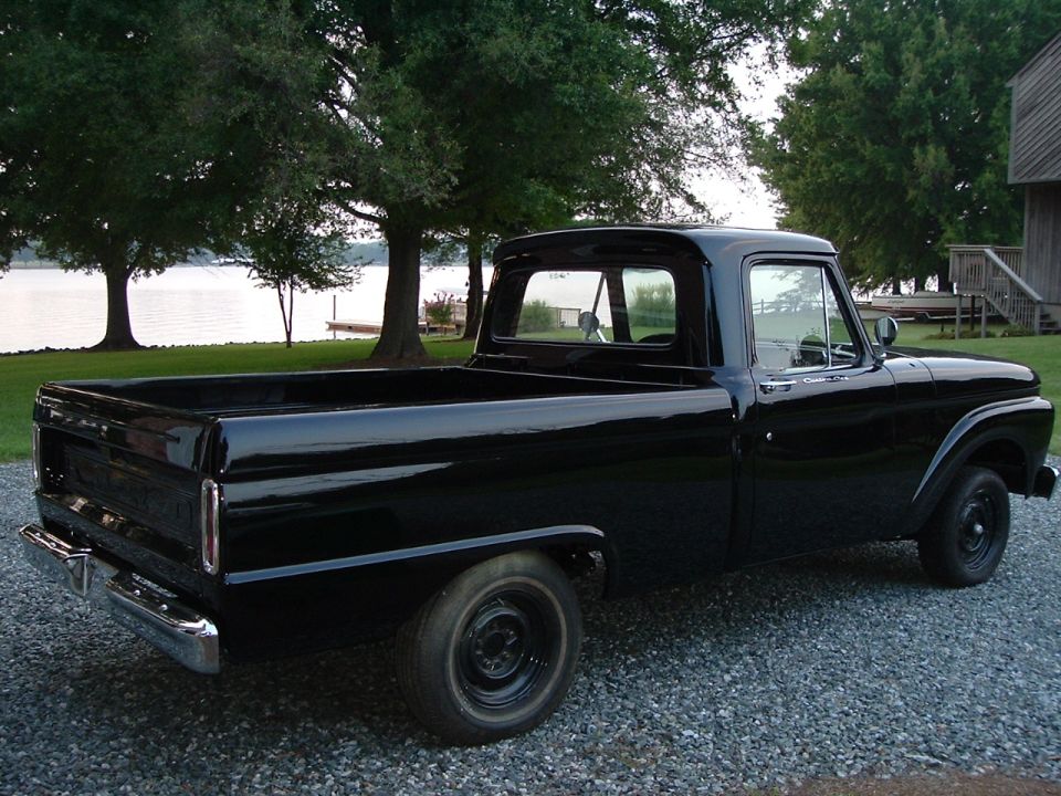 Black 1966 Ford F-100 pickup truck, 3q-front view